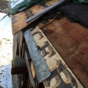 Grocery sign board discovered when asphalt shingles were removed from north wall roof of the wagon house.